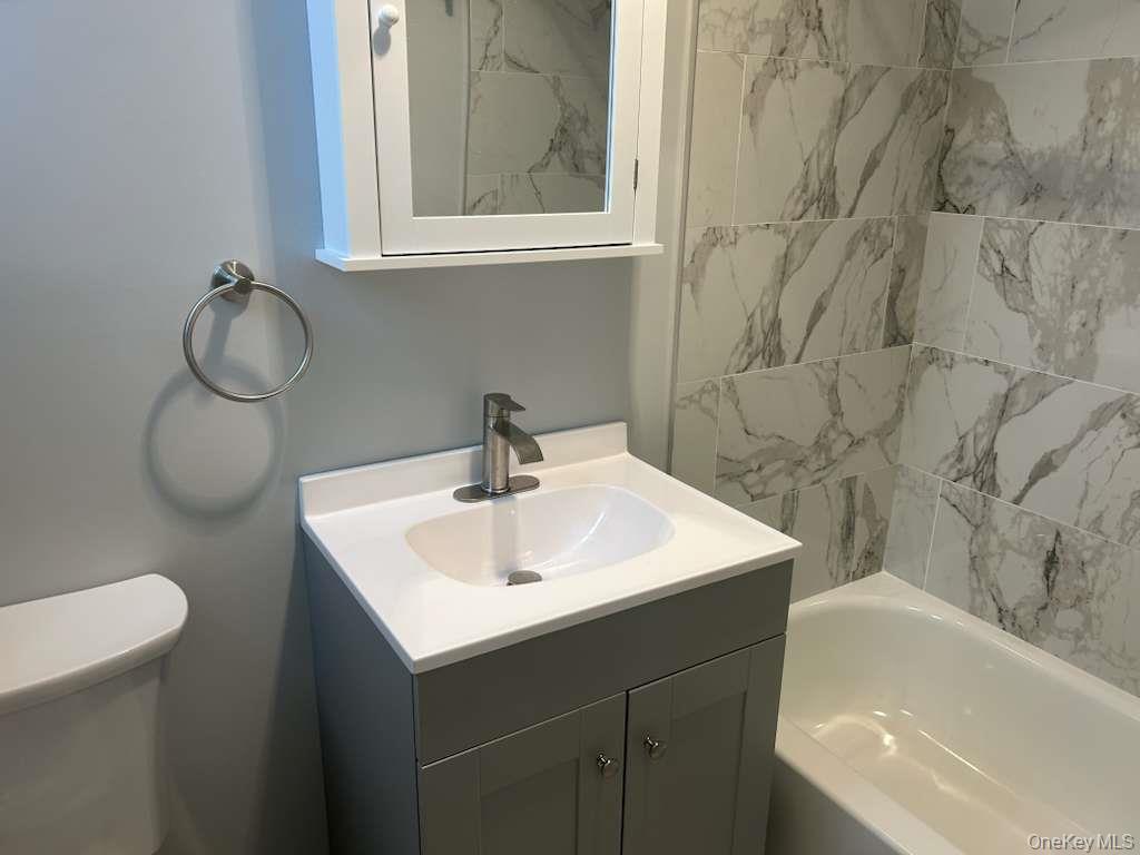 88-23 85th Street, Unit 1L Queens, NY 11421 - Photo 14 of 17 a bathroom with a sink and a bathtub