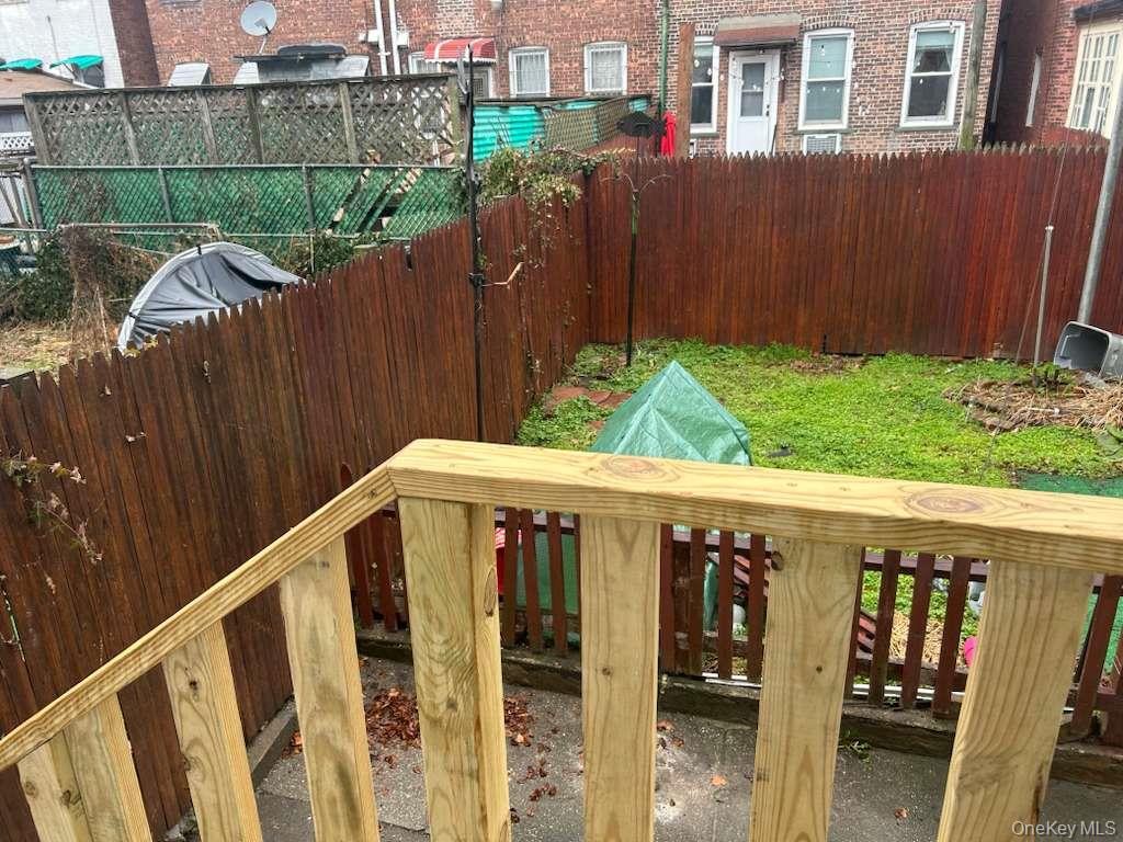 88-23 85th Street, Unit 1L Queens, NY 11421 - Photo 17 of 17 a view of wooden fence and a yard
