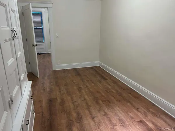 a view of wooden floor in an empty room