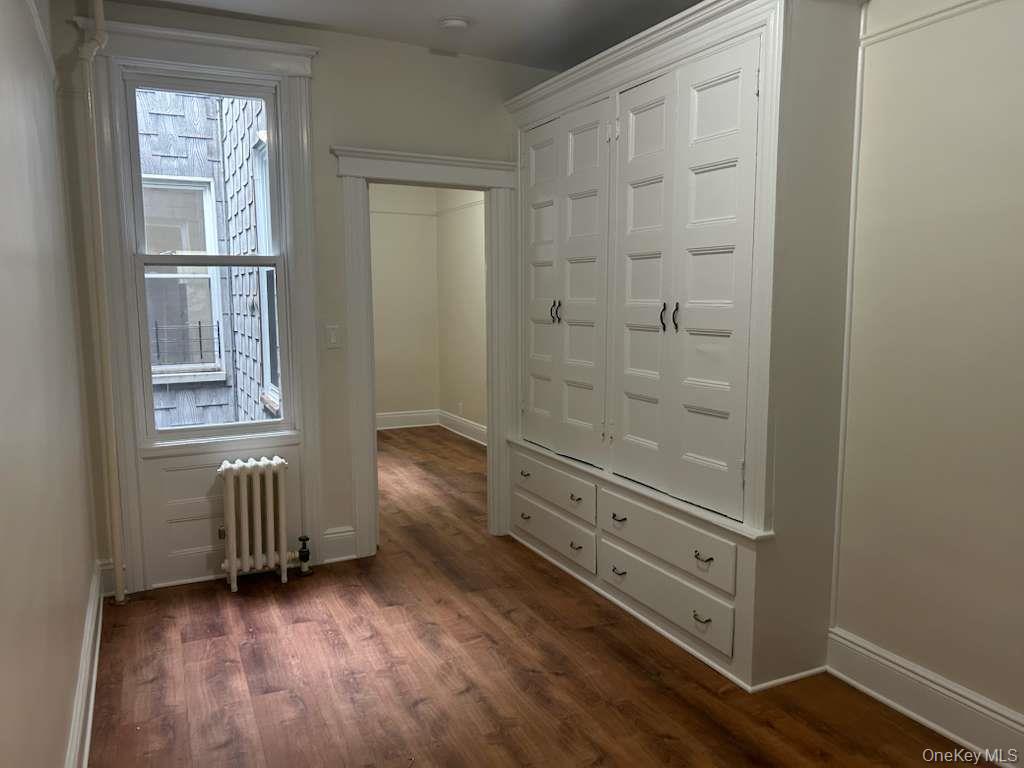 88-23 85th Street, Unit 1L Queens, NY 11421 - Photo 9 of 17 an empty room with windows