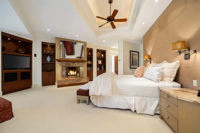a spacious bedroom with a bed and a fireplace