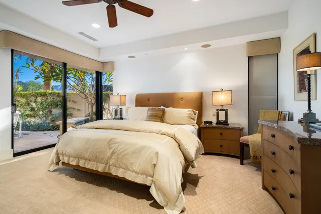 a spacious bedroom with a bed and a large window