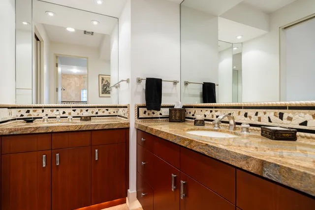 a bathroom with a double vanity sink and a mirror