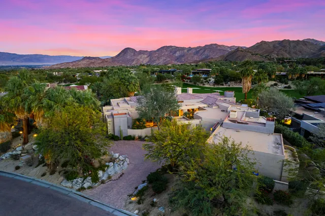 a view of a town with mountains in the background
