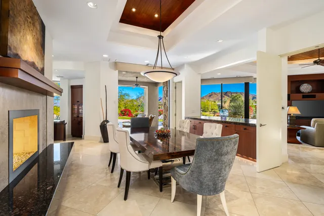 a dining room with furniture a chandelier and window