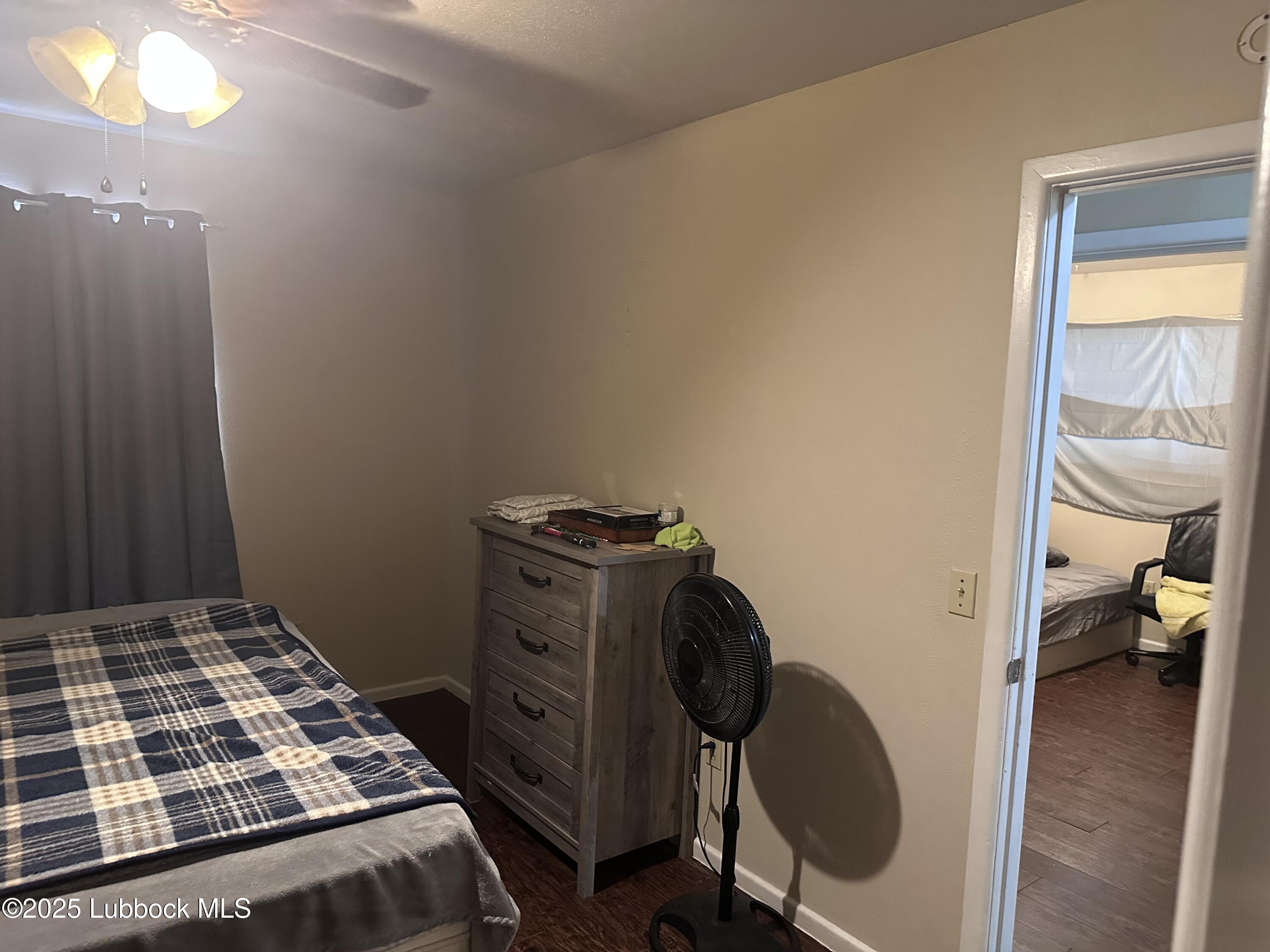 5202 41st Street Lubbock, TX 79414 - Photo 15 of 18 a bedroom with a bed and a mirror