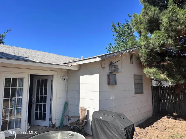 a backyard of a house with table and chairs
