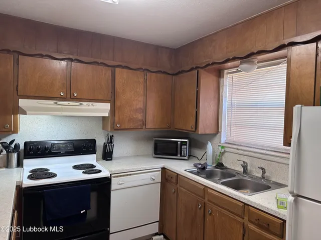 a kitchen with a sink cabinets and appliances