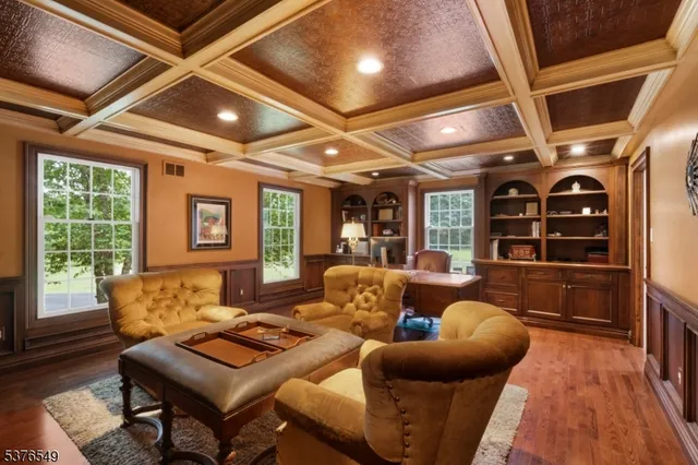 a living room with furniture a flat screen tv and windows