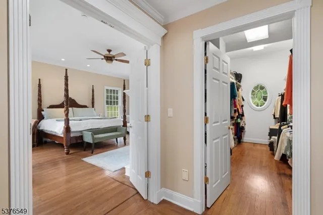 a view of a hallway with wooden floor and furniture