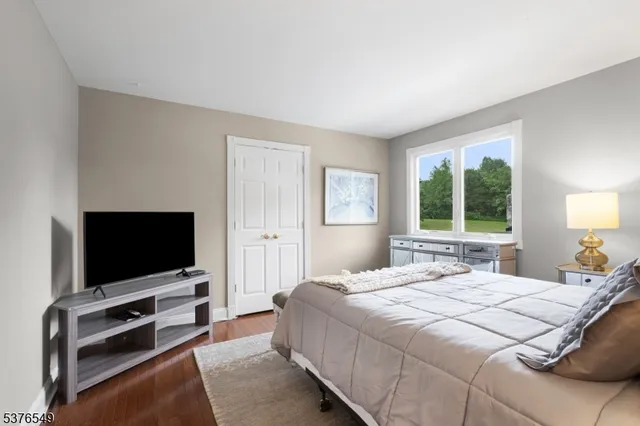 a bedroom with a flat screen tv and a bed