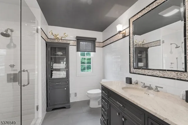 a spacious bathroom with a granite countertop sink toilet and shower
