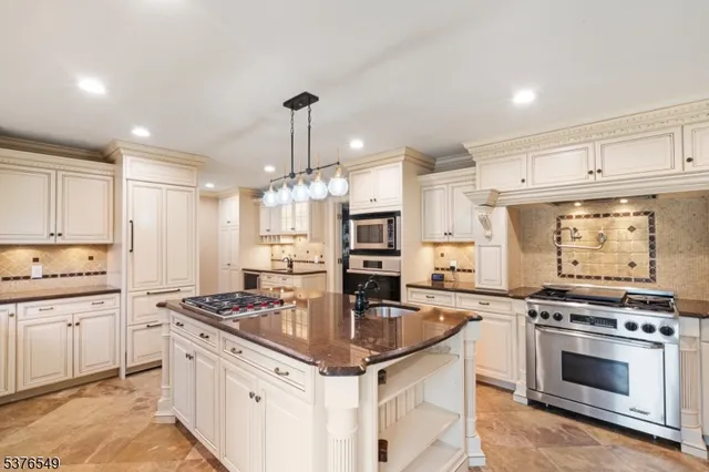 a kitchen with stainless steel appliances a stove sink and cabinets