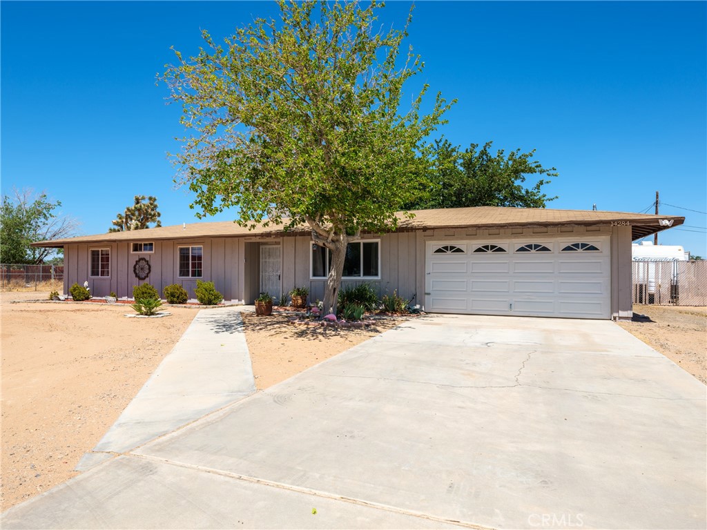 14284 Jicarilla Road Apple Valley, CA 92307 - Photo 1 of 1 front view of a house with a yard and potted plants