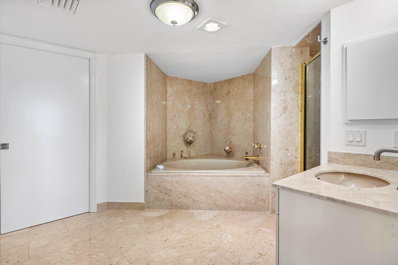 1500 South Ocean Boulevard, Unit 804 Boca Raton, FL 33432 - Photo 13 of 45 a spacious bathroom with a tub sink and mirror