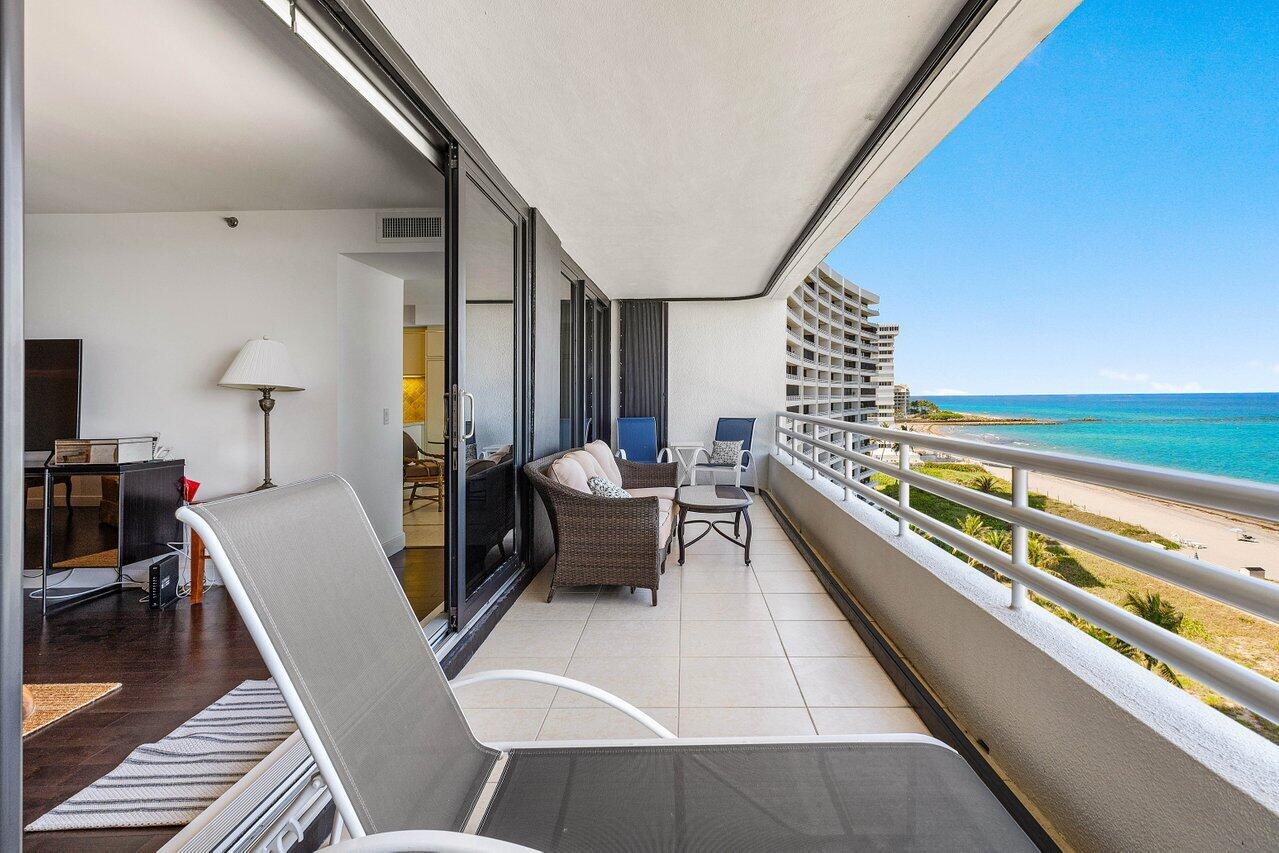 1500 South Ocean Boulevard, Unit 804 Boca Raton, FL 33432 - Photo 24 of 45 a balcony with chairs and wooden floor