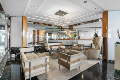 a living room with lots of furniture and kitchen view