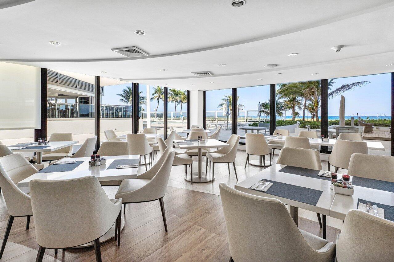 1500 South Ocean Boulevard, Unit 804 Boca Raton, FL 33432 - Photo 29 of 45 a view of a dining room with furniture large windows and wooden floor