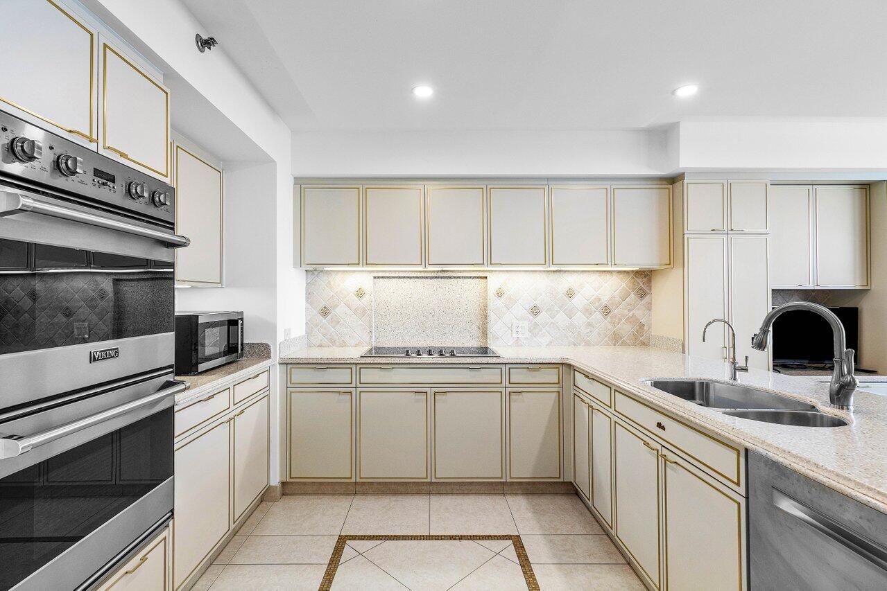 1500 South Ocean Boulevard, Unit 804 Boca Raton, FL 33432 - Photo 7 of 45 a kitchen with granite countertop a sink stainless steel appliances and cabinets