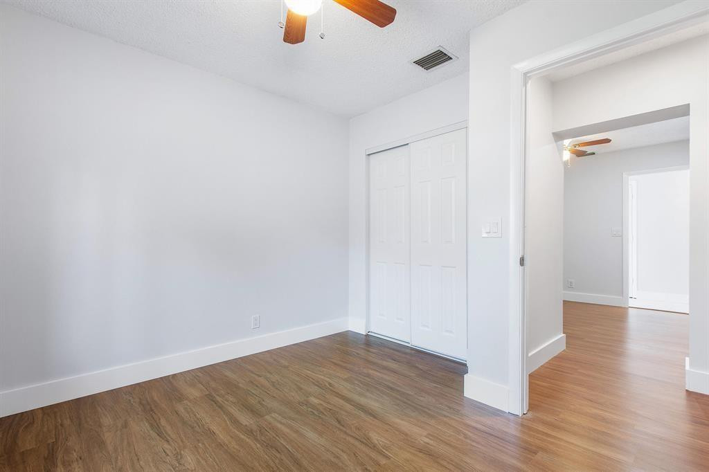 9611 Saddlebrook Drive Boca Raton, FL 33496 - Photo 12 of 15 a view of an empty room with wooden floor