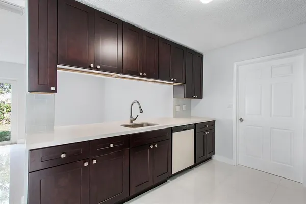 a kitchen with a sink and cabinets