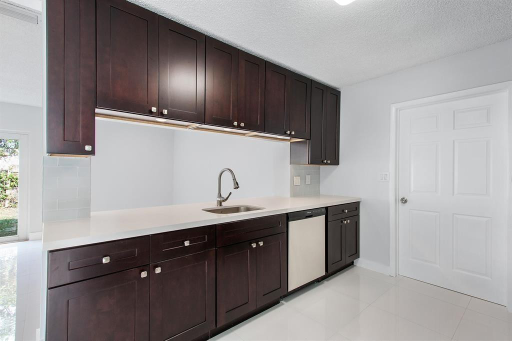 9611 Saddlebrook Drive Boca Raton, FL 33496 - Photo 4 of 15 a kitchen with a sink and cabinets