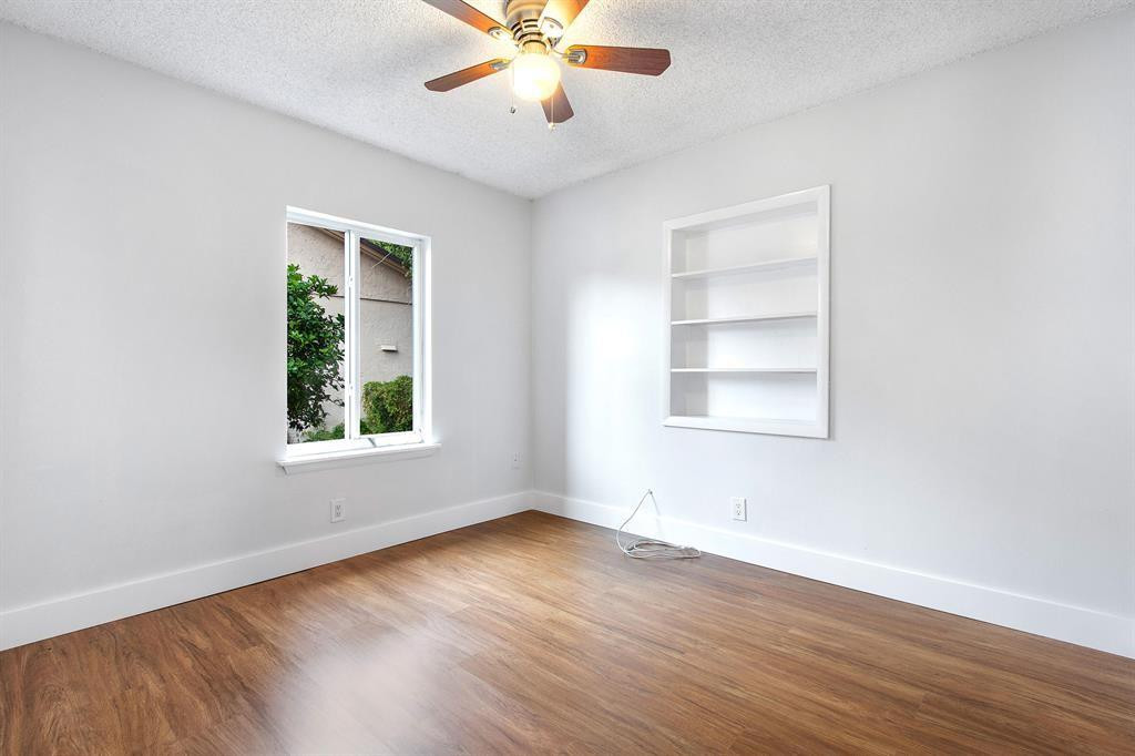 9611 Saddlebrook Drive Boca Raton, FL 33496 - Photo 6 of 15 an empty room with wooden floor chandelier fan and windows