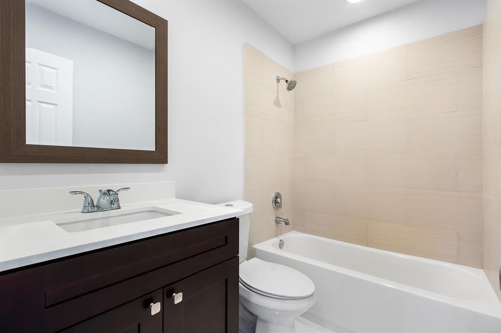 9611 Saddlebrook Drive Boca Raton, FL 33496 - Photo 7 of 15 a bathroom with a sink a toilet a mirror and shower