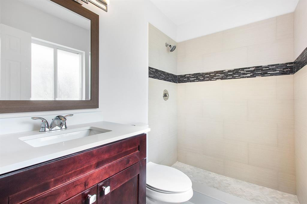 9611 Saddlebrook Drive Boca Raton, FL 33496 - Photo 8 of 15 a bathroom with a sink a toilet and shower