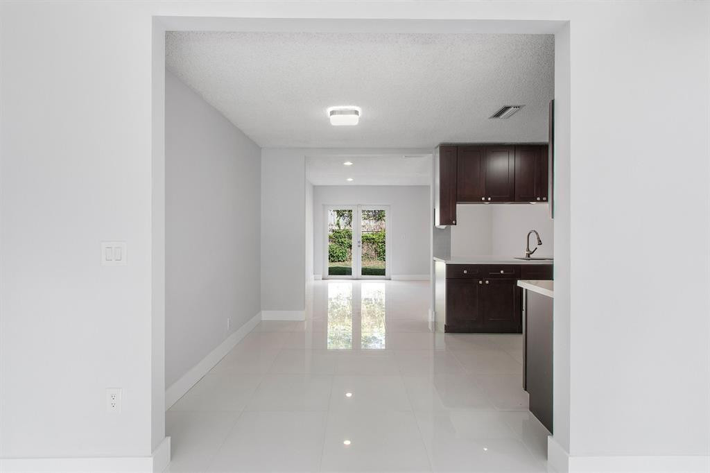 9611 Saddlebrook Drive Boca Raton, FL 33496 - Photo 9 of 15 a living room with furniture and a flat screen tv