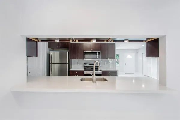 a view of kitchen with furniture and refrigerator