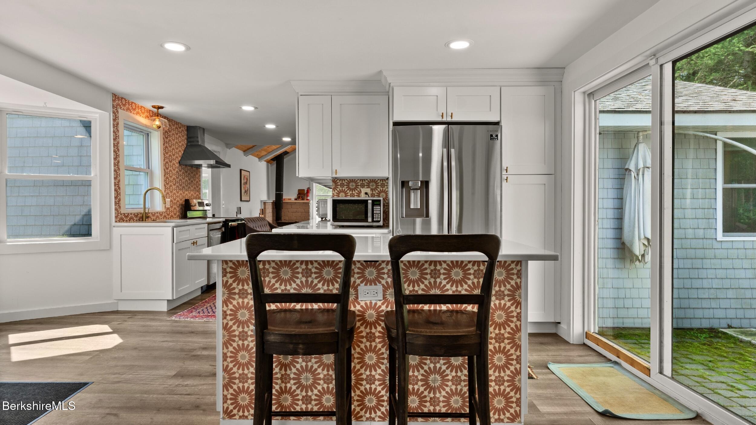 418 Monterey Road Great Barrington, MA 01230 - Photo 6 of 28 a kitchen with stainless steel appliances granite countertop a refrigerator and a stove top oven