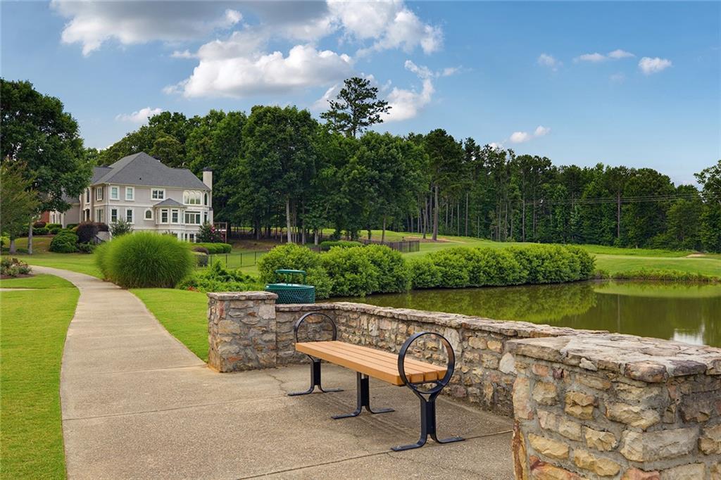 14442 Club Circle Milton, GA 30004 - Photo 71 of 82 a view of a garden with plants and a lake view