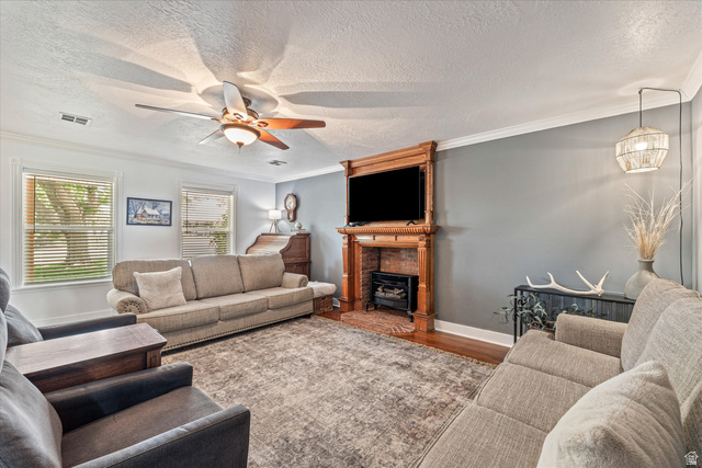246 West Mount Charm Road Toquerville, UT 84774 - Photo 13 of 70 Living room featuring ornamental molding, a textured ceiling, wood finished floors, and ceiling fan
