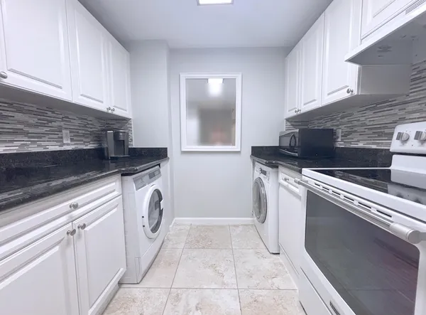 a utility room with sink dryer and washer