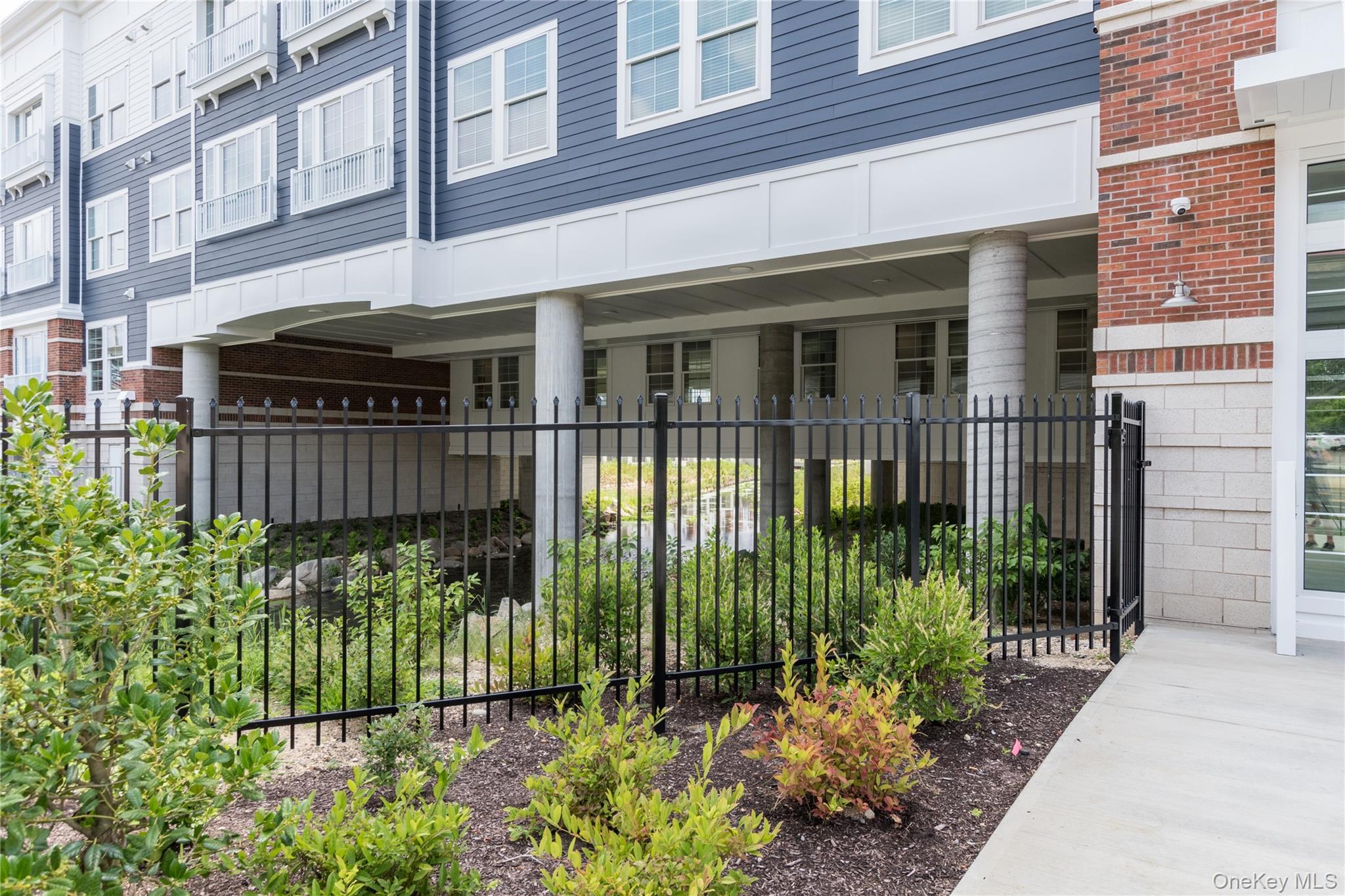 75 East Hoffman Avenue, Unit 1003 Lindenhurst, NY 11757 - Photo 6 of 7 front view of a house with a garden