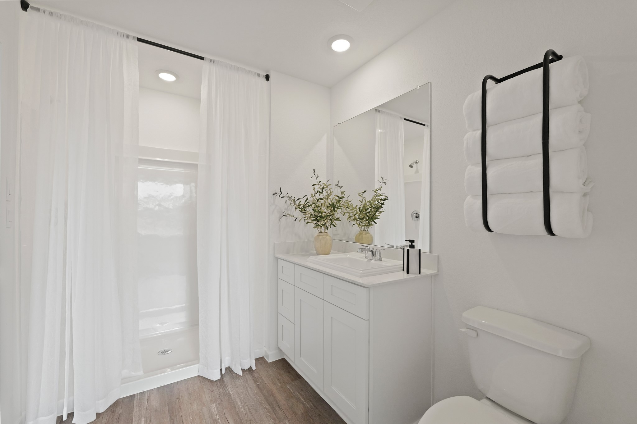 20034 Fibonacci Street New Caney, TX 77357 - Photo 12 of 24 a bathroom with a shower sink vanity and toilet