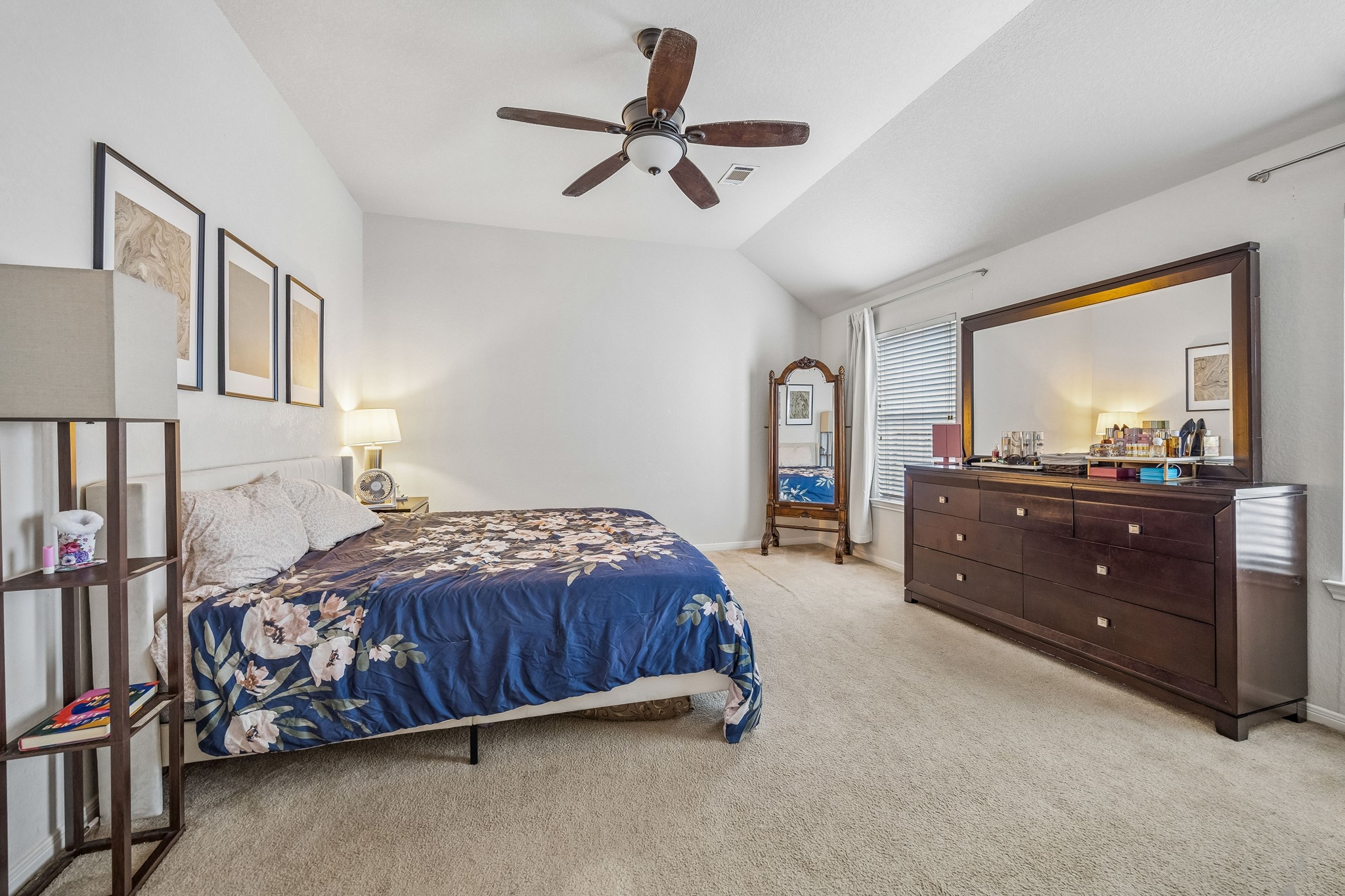 24027 Floragate Drive Spring, TX 77373 - Photo 13 of 21 a bedroom with a bed and a dresser