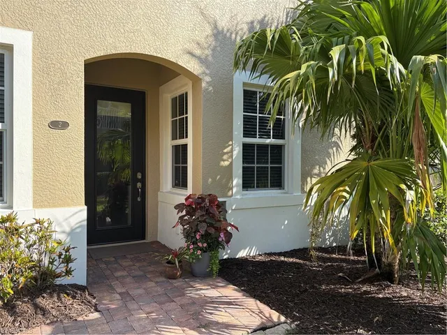 a couple of potted plants in front of a house
