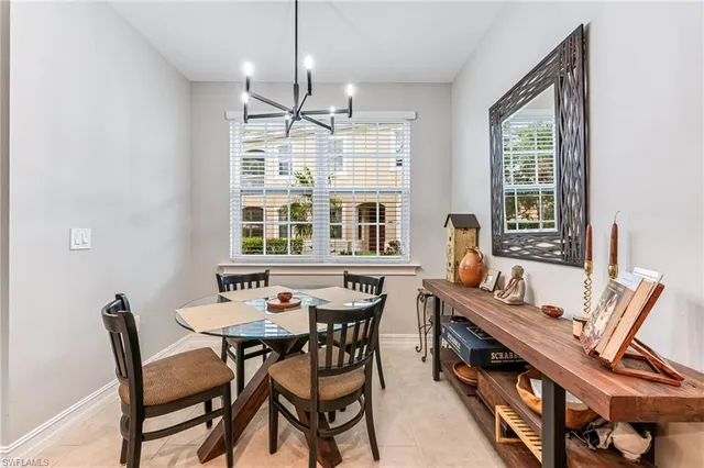 a kitchen with a counter space a sink and chairs