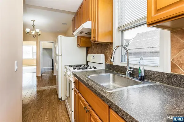 a kitchen with a sink a counter top space and stainless steel appliances