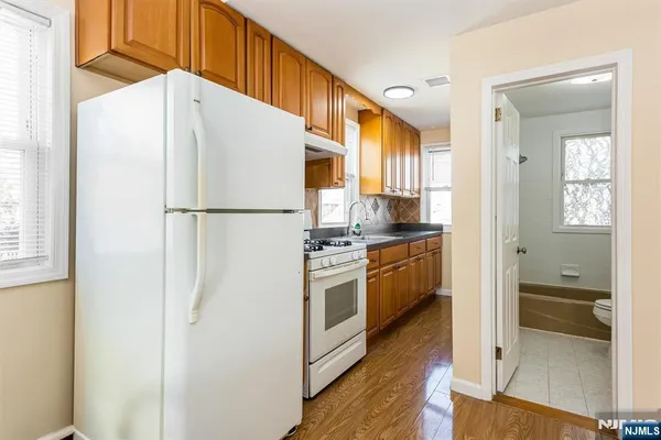 a white refrigerator freezer and a stove sitting inside of a kitchen
