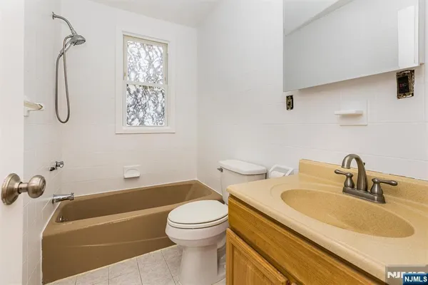a bathroom with a sink a toilet and a bathtub