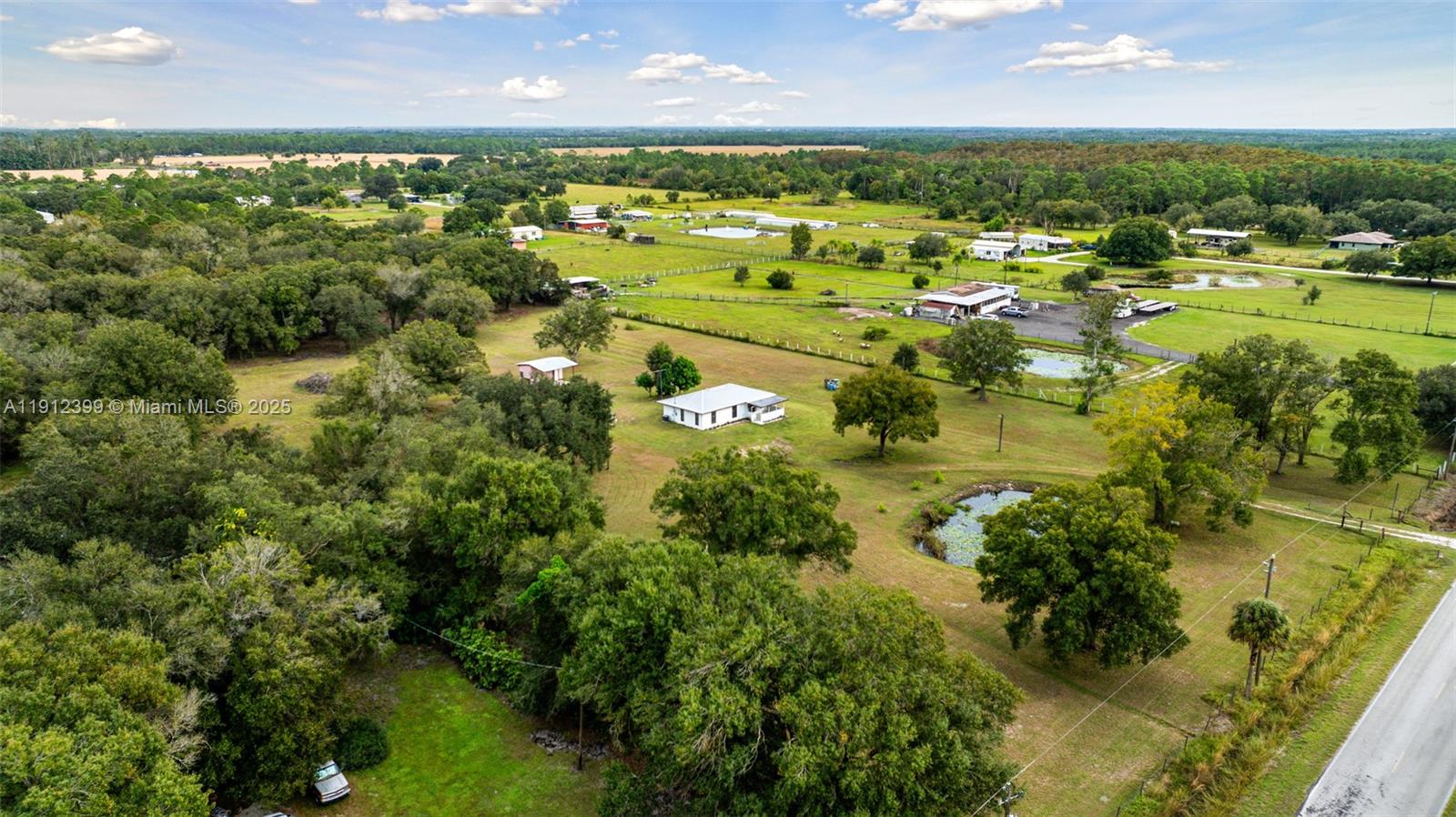 2404 Silver Lake Road LaBelle, FL 33935 - Photo 13 of 89 an aerial view of residential houses with outdoor space and trees