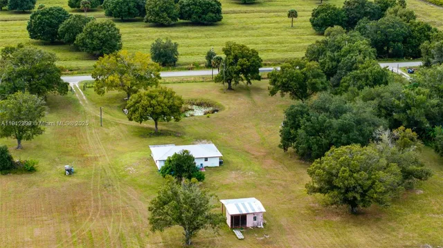 an aerial view of residential houses with outdoor space and swimming pool
