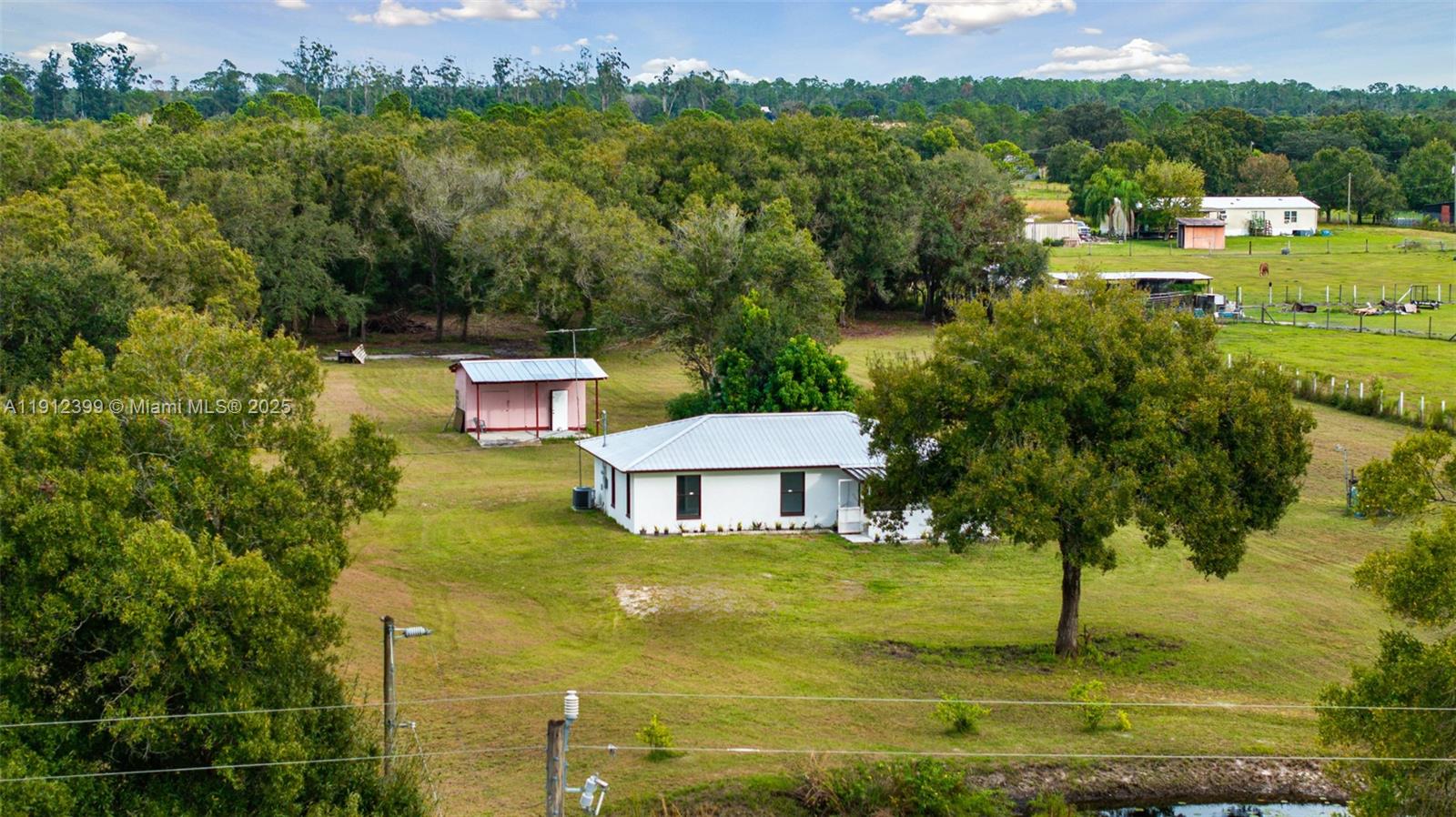 2404 Silver Lake Road LaBelle, FL 33935 - Photo 34 of 89 a view of a swimming pool with a yard
