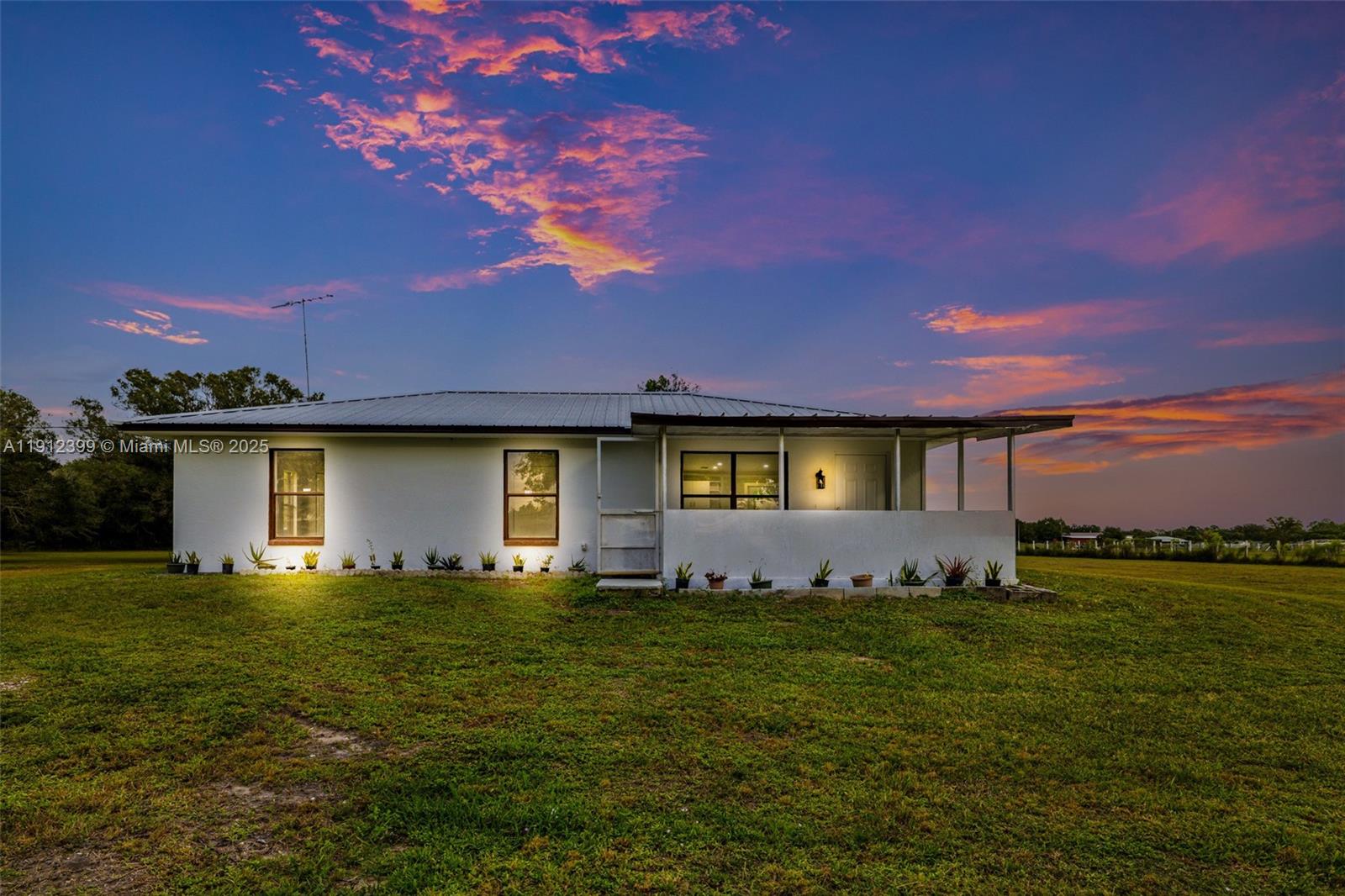2404 Silver Lake Road LaBelle, FL 33935 - Photo 46 of 89 a front view of a house with a yard and garage