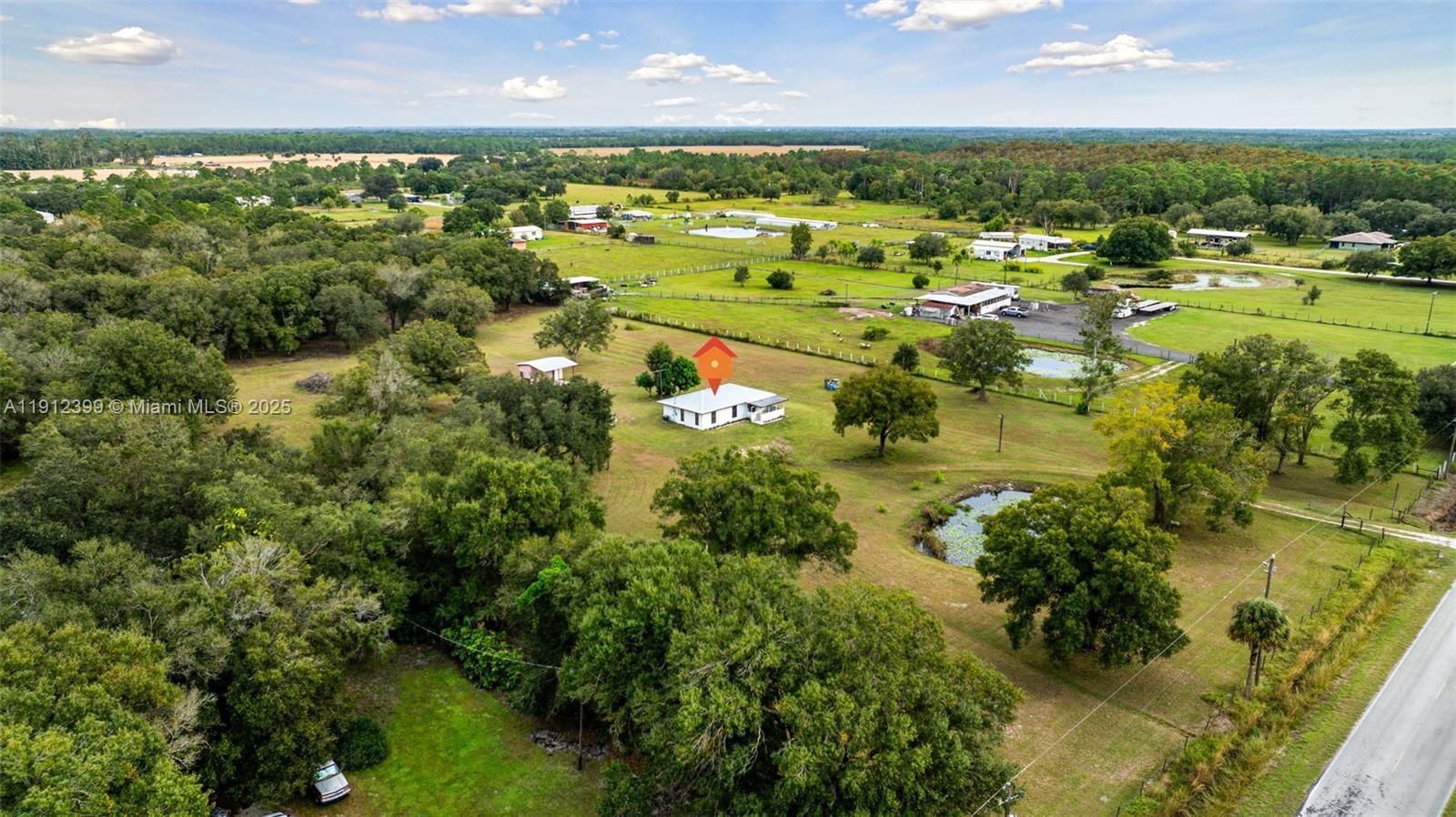 2404 Silver Lake Road LaBelle, FL 33935 - Photo 50 of 89 an aerial view of residential houses with outdoor space and trees