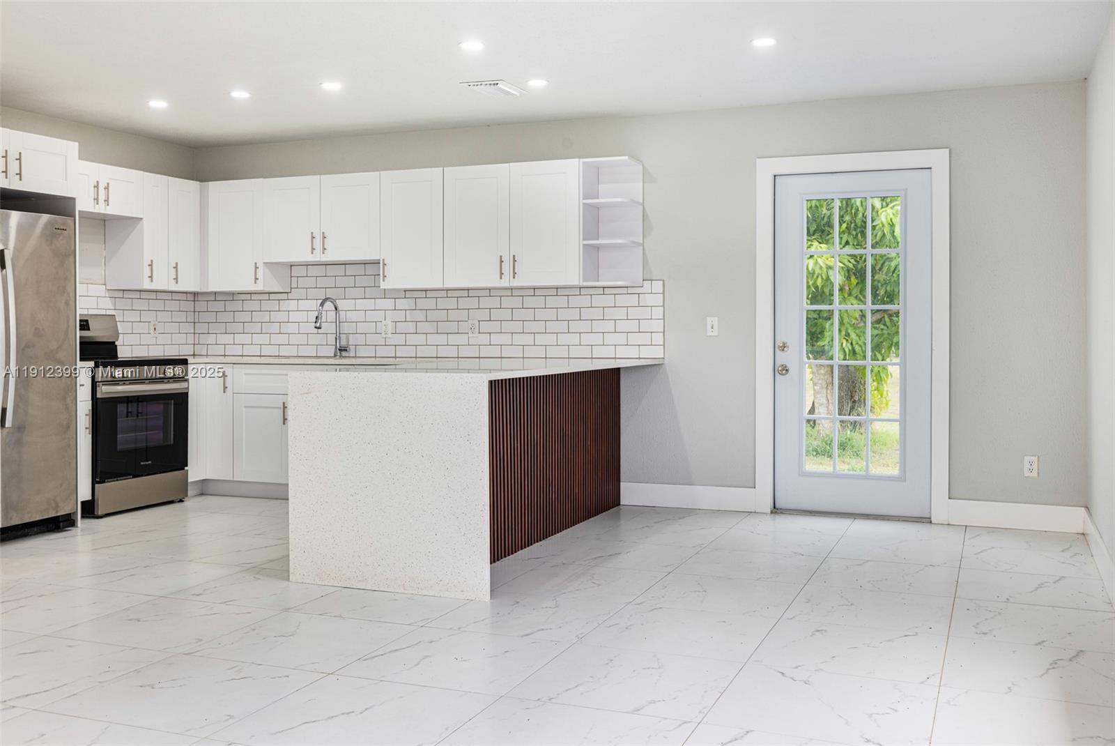2404 Silver Lake Road LaBelle, FL 33935 - Photo 52 of 89 a view of a kitchen with a sink and dishwasher a refrigerator with white cabinets