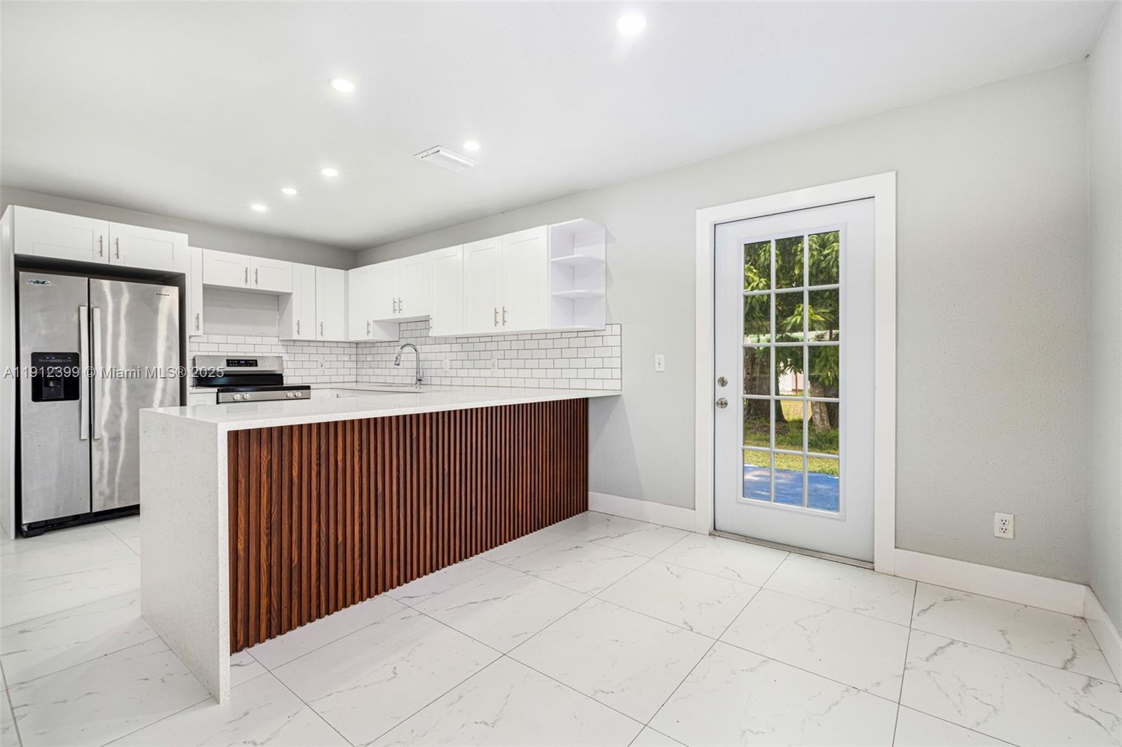 2404 Silver Lake Road LaBelle, FL 33935 - Photo 59 of 89 a kitchen with stainless steel appliances granite countertop a stove a refrigerator a sink and dishwasher